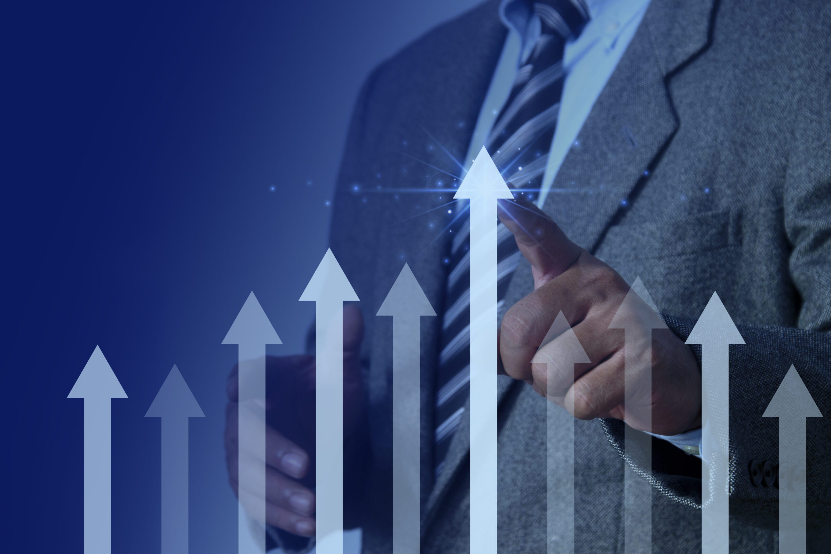 Business man hand pointing arrow graph corporate future growth plan. Profit increasing, leadership concept A man in a suit and tie pointing to an upward arrow.